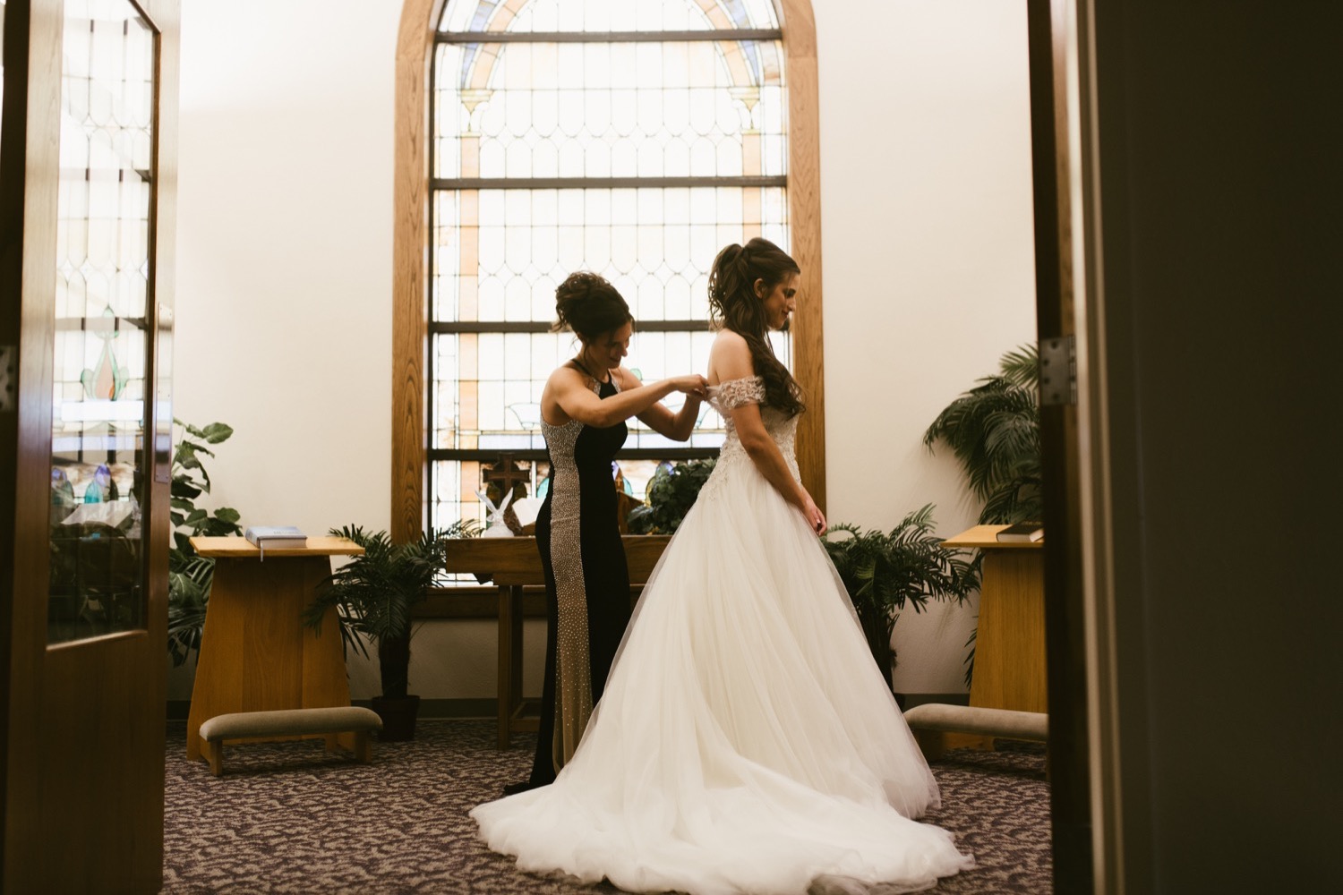bride getting ready in i do bridal boutique ballgown at fort wayne winter wedding