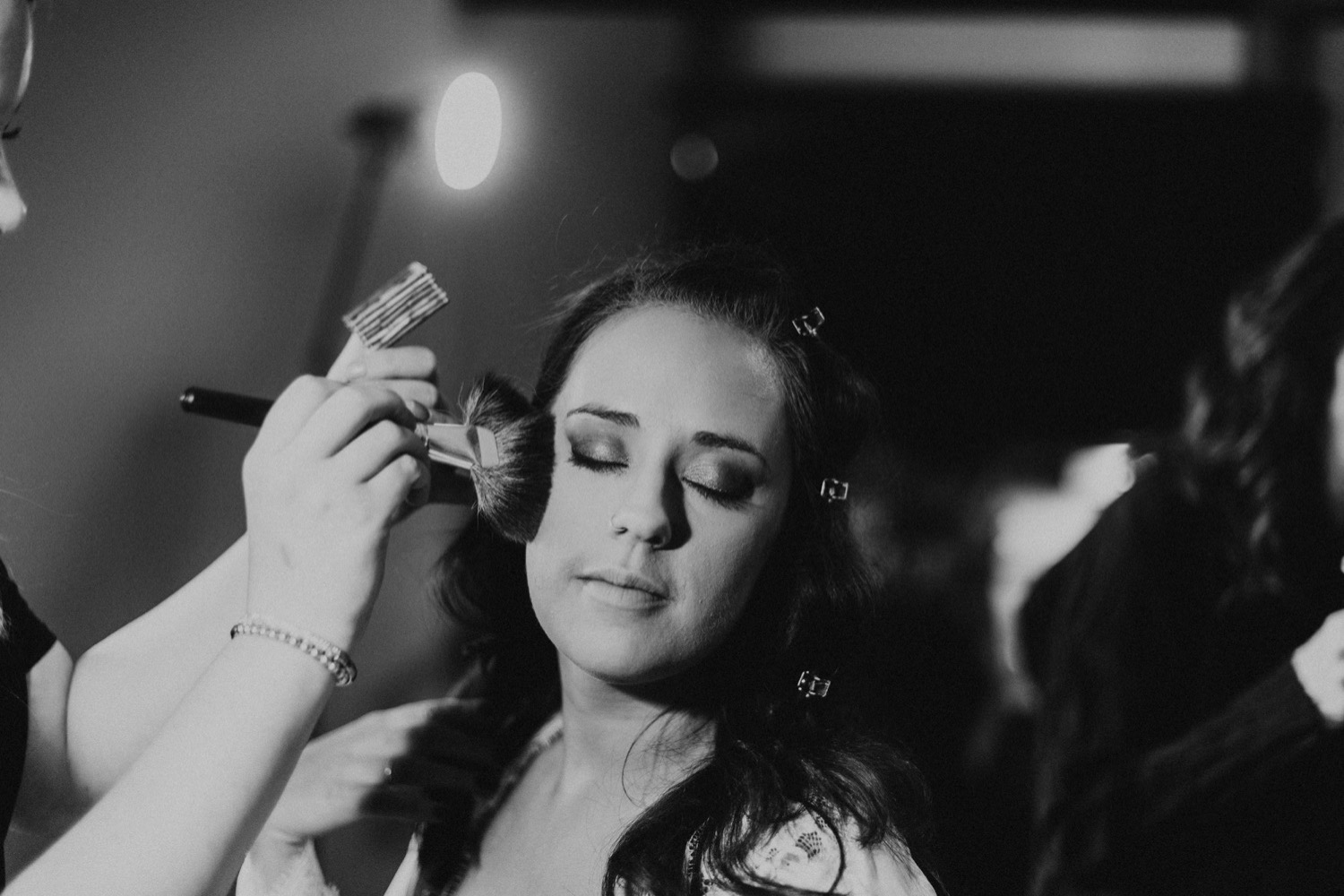 Black and white photo of Chicago bride getting makeup done
