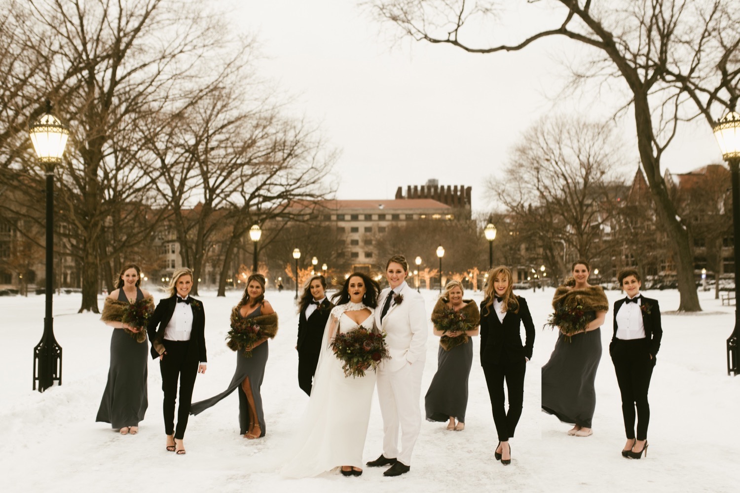 Chicago bride and bride with wedding party in the back on a snowy day.
