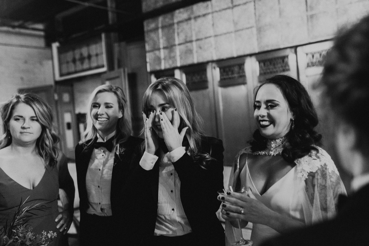 Black and white photo of wedding ceremony guests reaction to wedding.