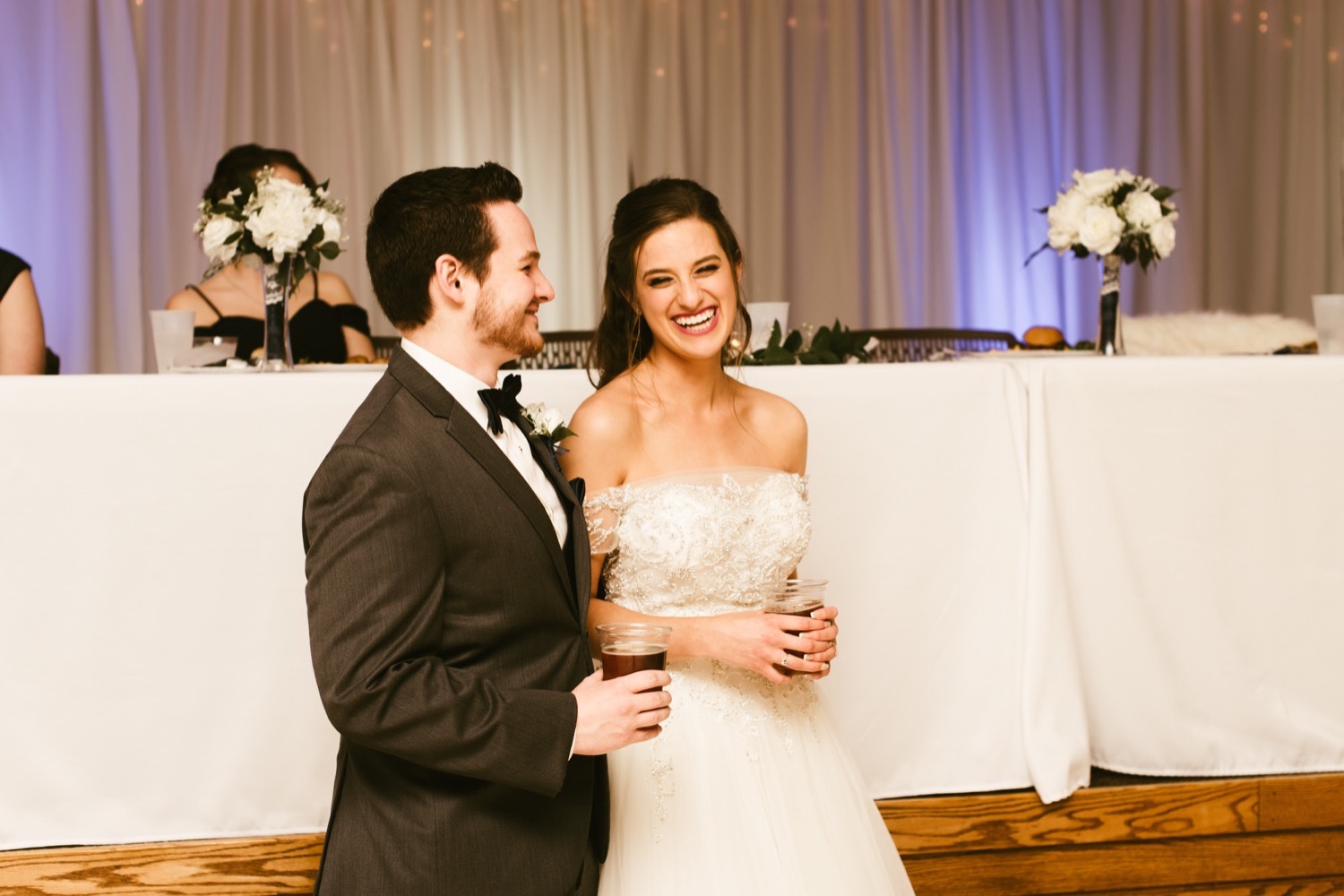 bride and groom laughing at reception at fort wayne winter wedding
