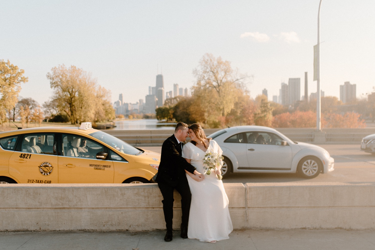 Bride and groom kissing on lake shore drive in chicago.