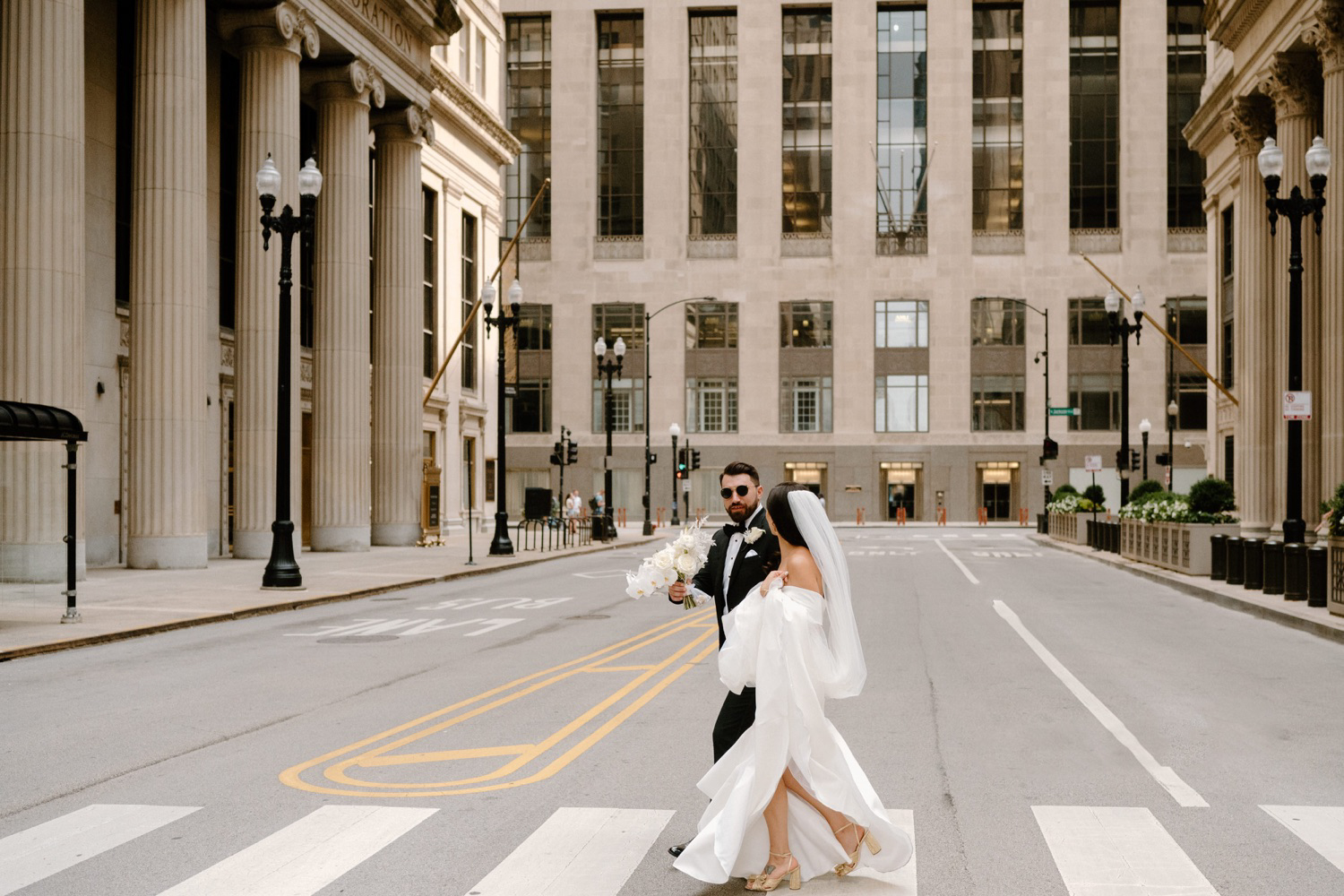 Modern and elegant Chicago bride and groom walking the streets of downtown Chicago before the wedding ceremony.