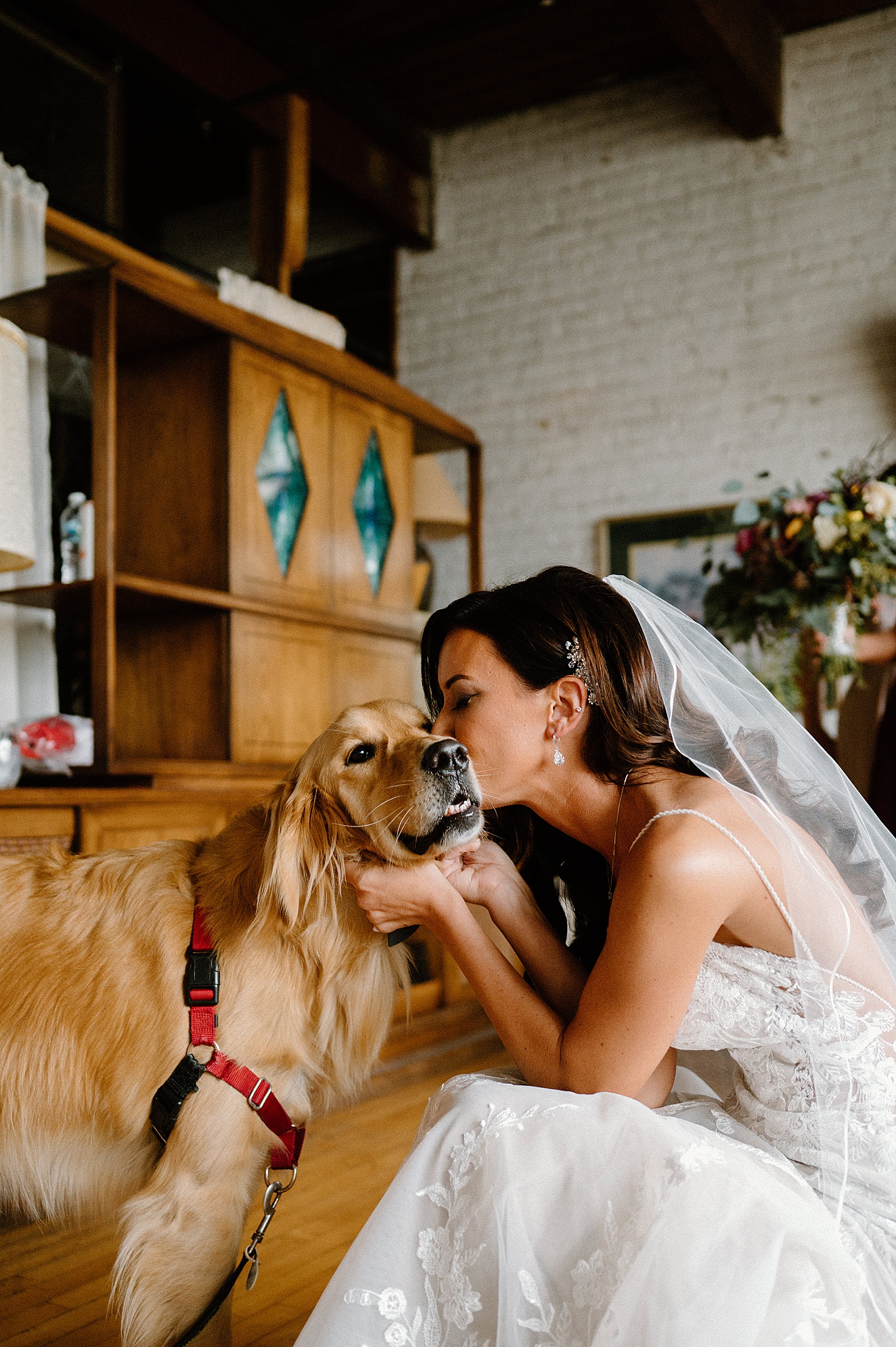 Bride kissing her dog before her wedding ceremony 