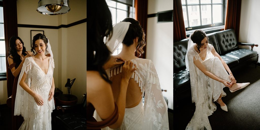 Bride in boho wedding dress putting on her shoes on a leather couch before her ceremony at The Joinery. 