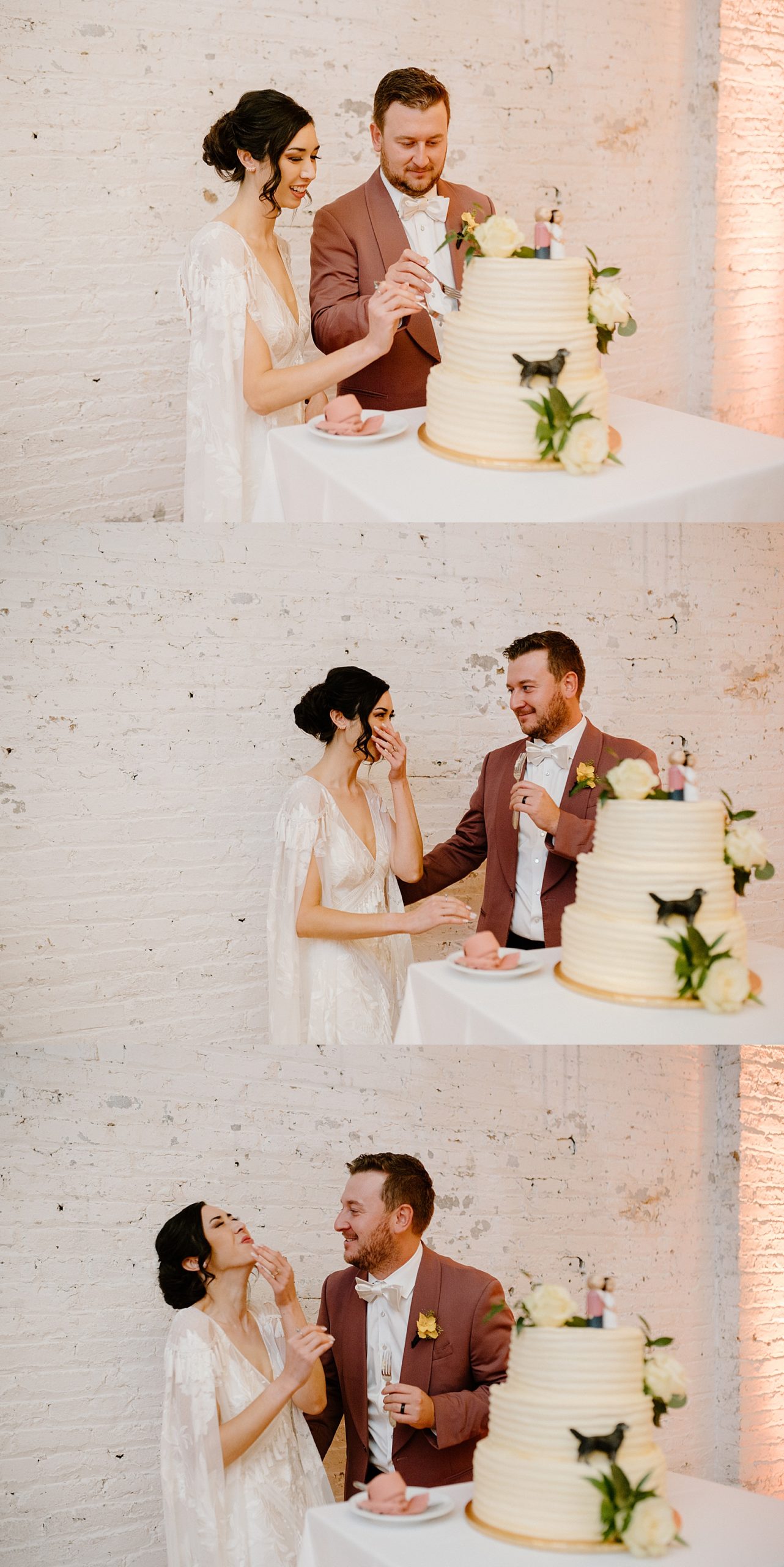 Newlyweds cutting their three tier white frosted cake with large white roses on it. 