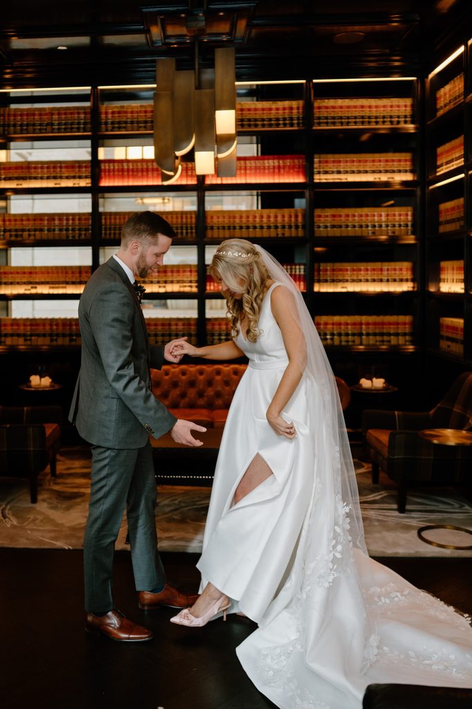 Bride and groom share a moment in the library at their boho wedding 