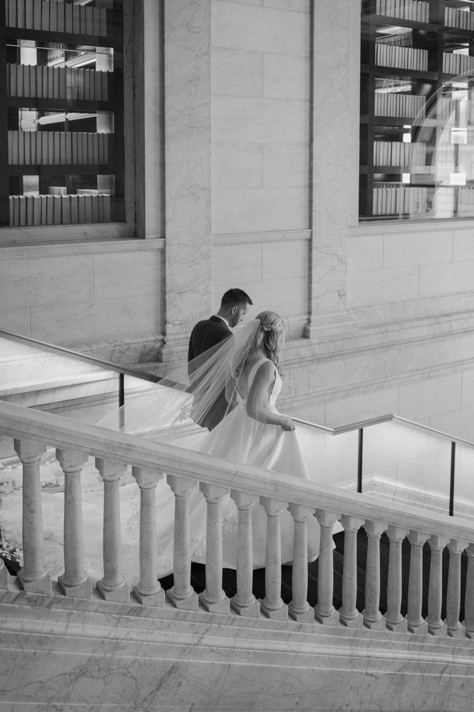 Bride and groom walking down marble stairs by midwest photographer indigo lace 