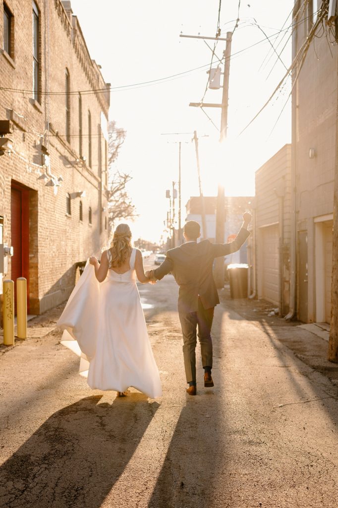 Bride and groom walking down an alleyway by midwest photographer indigo lace 