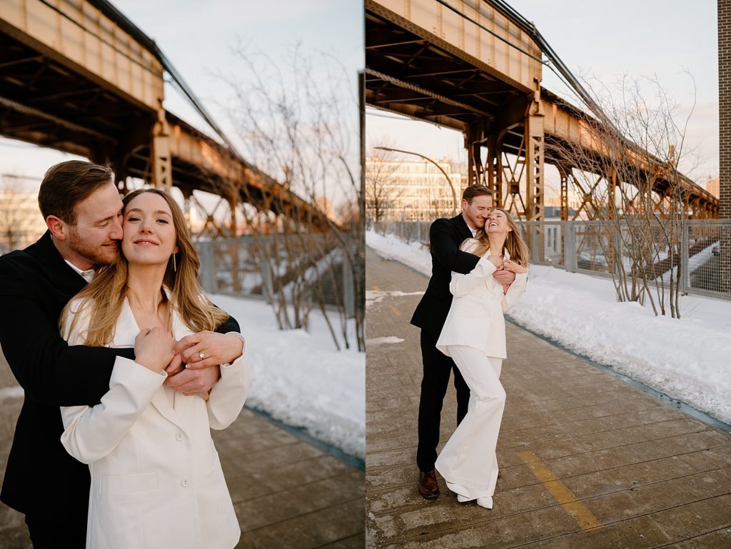 Engaged couple hugging under a bridge in the snow for a photo shoot 