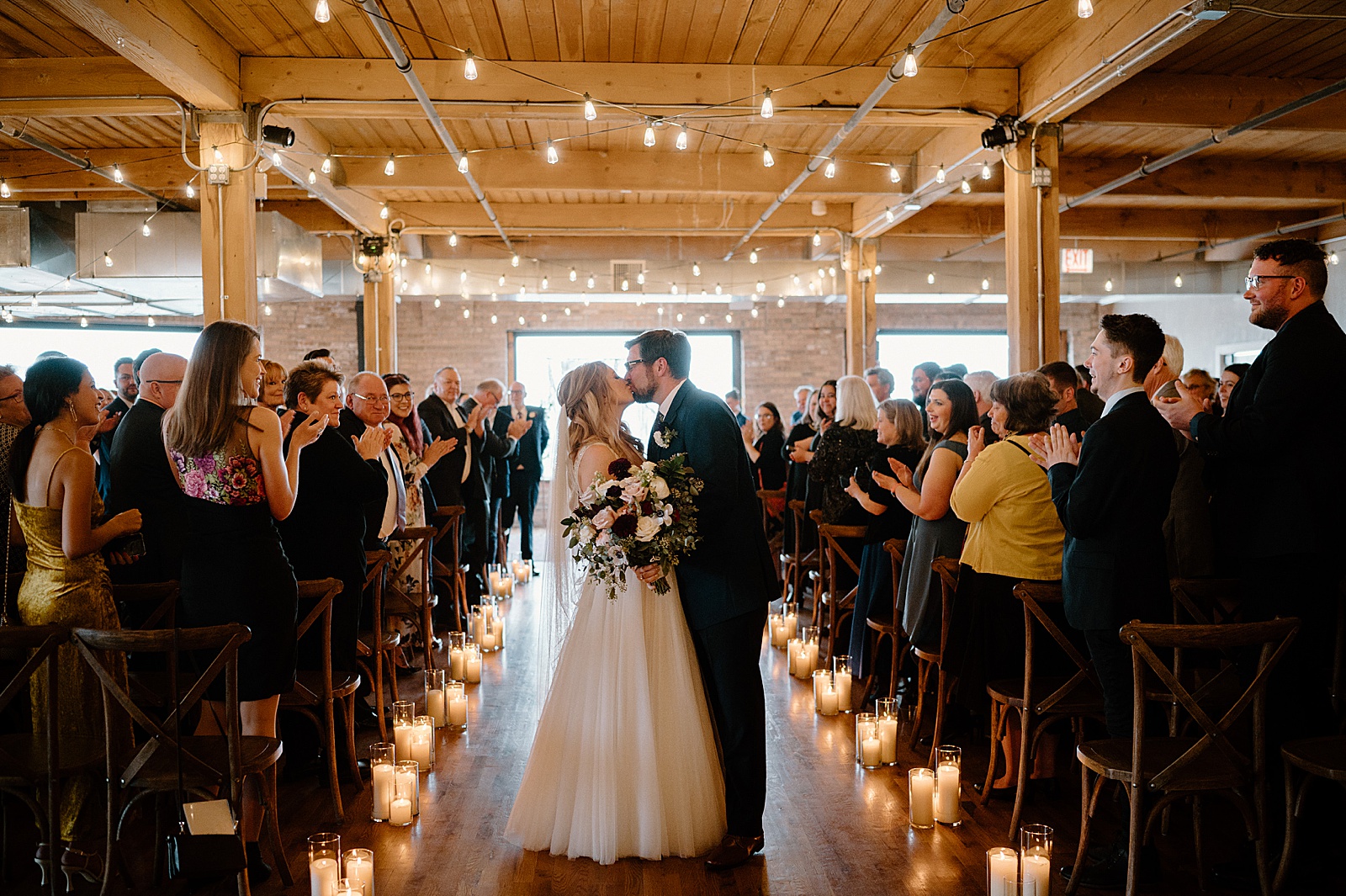 Newlyweds kiss at the end of the aisle at Chicago venue 