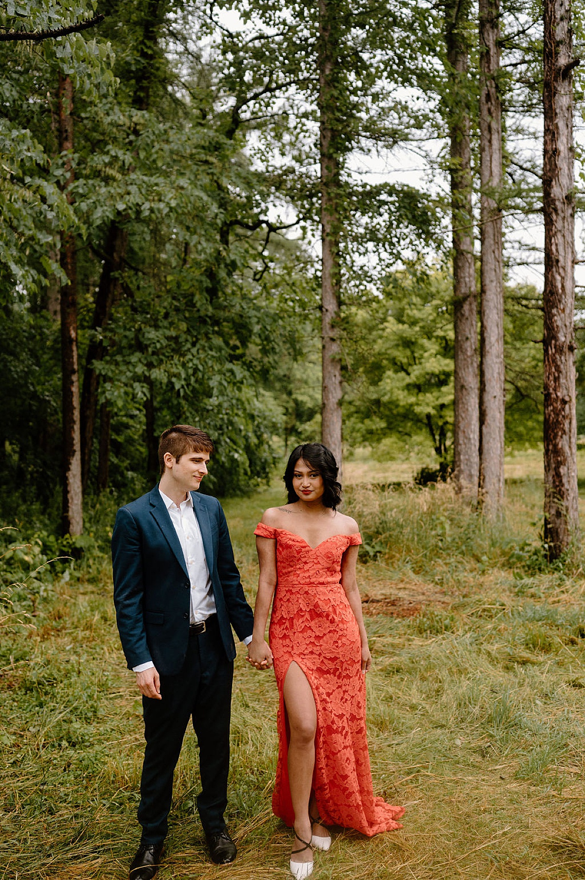 elegant couple in evening wear pose under trees during mortem arboretum engagement session