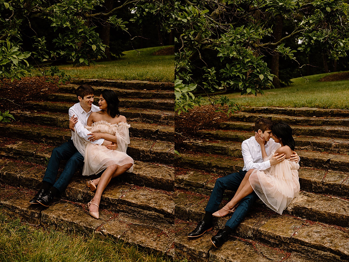 man and fiancee in romantic dress pose on steps during shoot by midwest wedding photographer