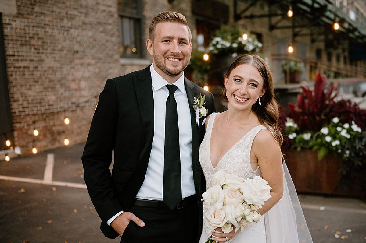 bride and groom pose at industrial city wedding venue during shoot by midwest wedding photographer