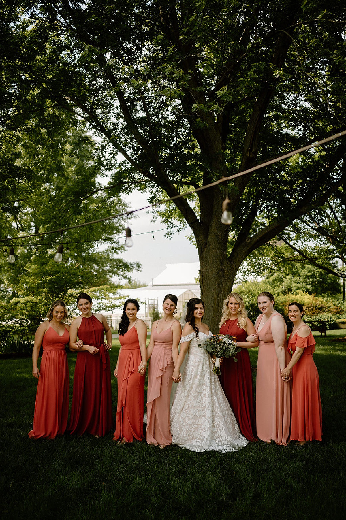 bride in boho embellished gown poses with bridesmaids before wedding shot by indigo lace collective