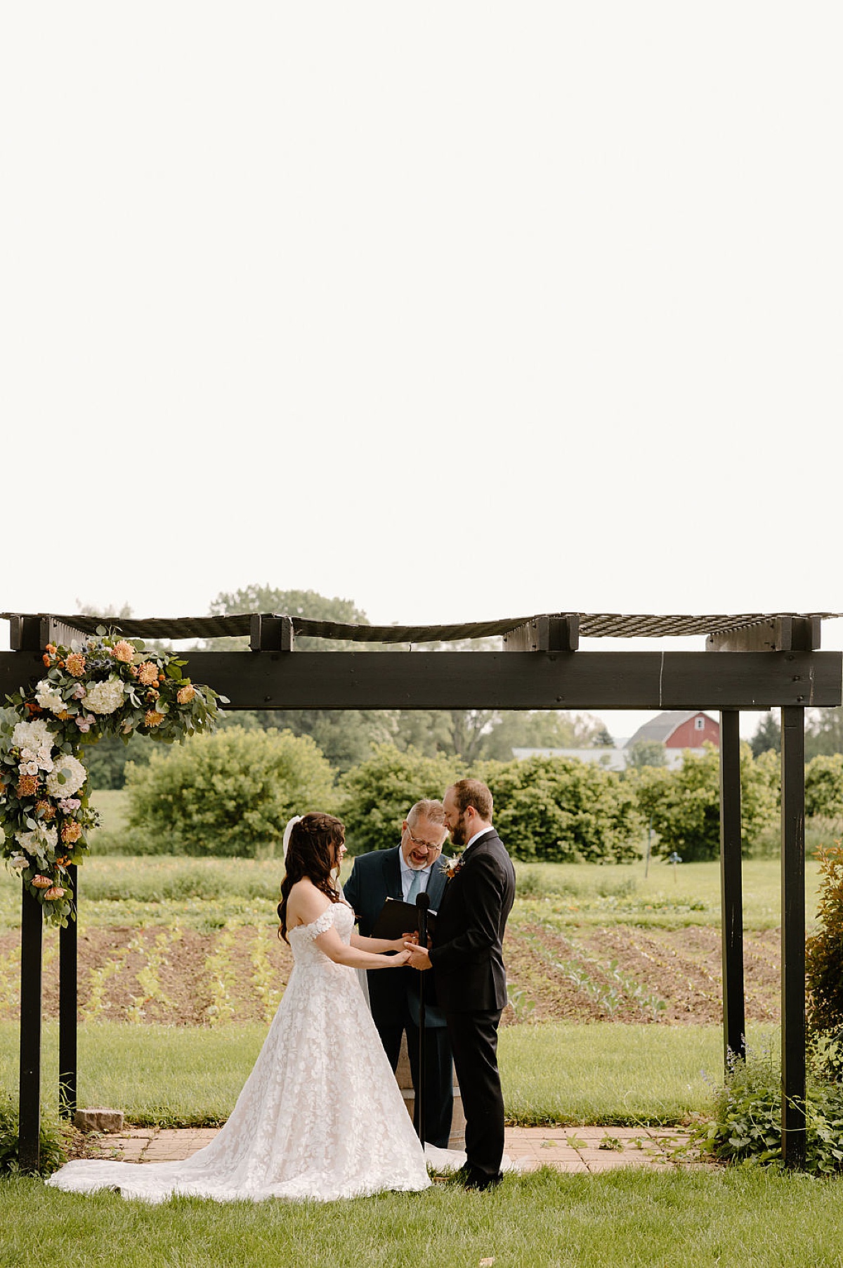 bride and groom share vows during wedding ceremony outdoors at illinois venue shot by indigo lace collective