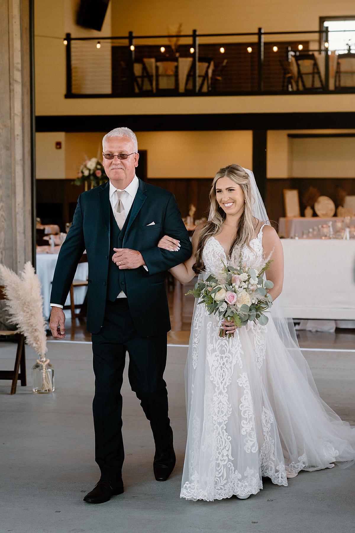 bride and father walk the aisle during boho ceremony shot by midwest wedding photographer