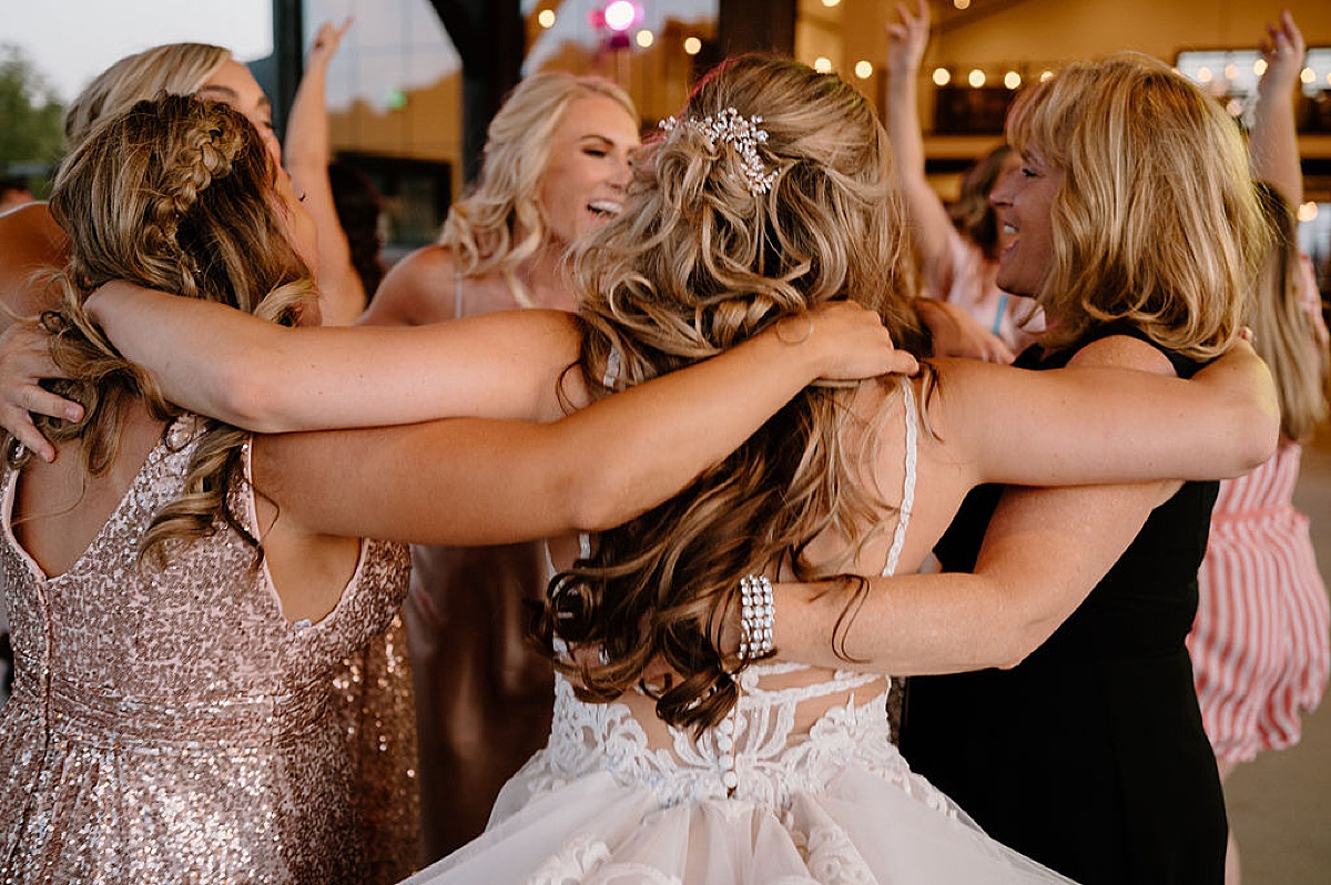 bride dances with bridesmaids and friends during reception at union 12 in fort wayne | indigo lace collective