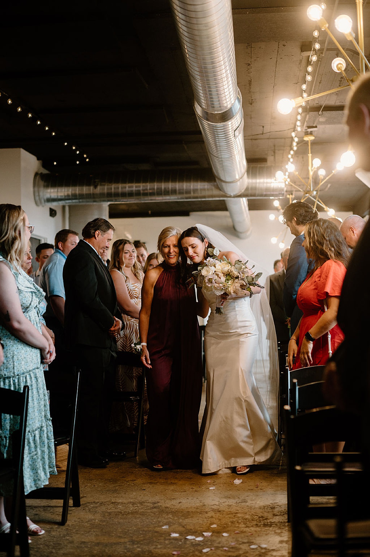 elegant mother walks bride up the aisle during intimate ceremony shot by midwest wedding photographer