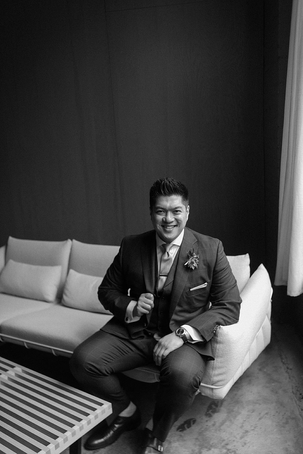 groom gets ready in sleek hotel before Ravenswood event center spring wedding