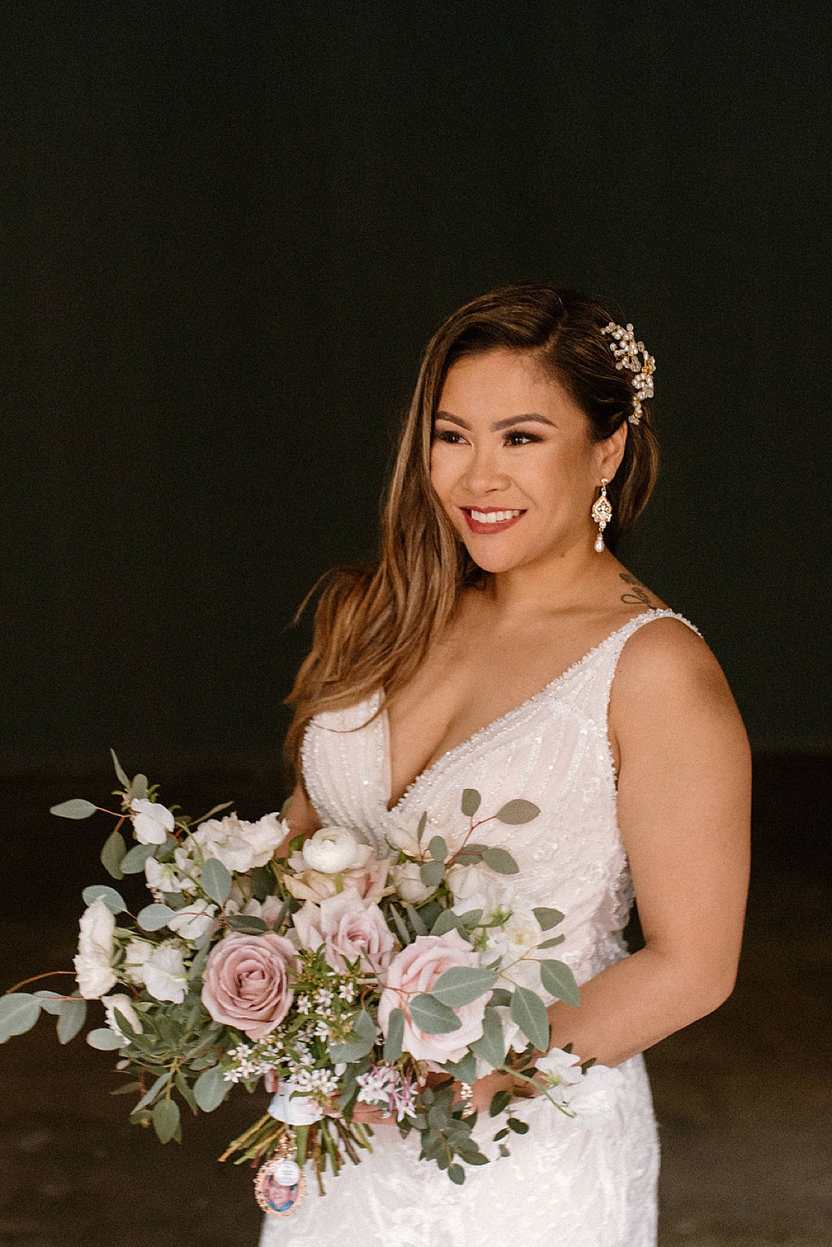 bride in beaded gown and classic pastel rose bouquet poses for chicago wedding photographer