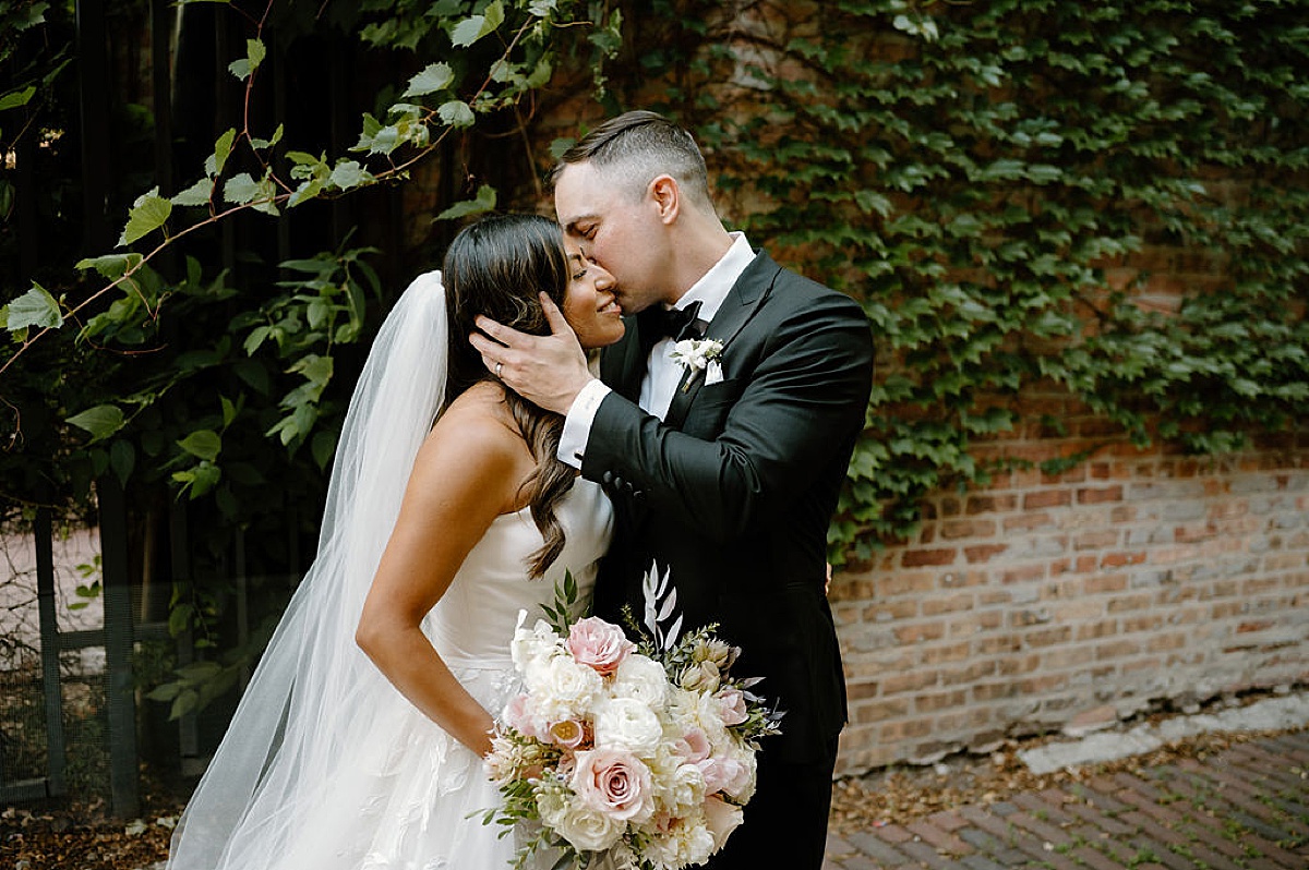 husband kisses bride's cheek after classy Chicago wedding shot by Indigo Lace Collective