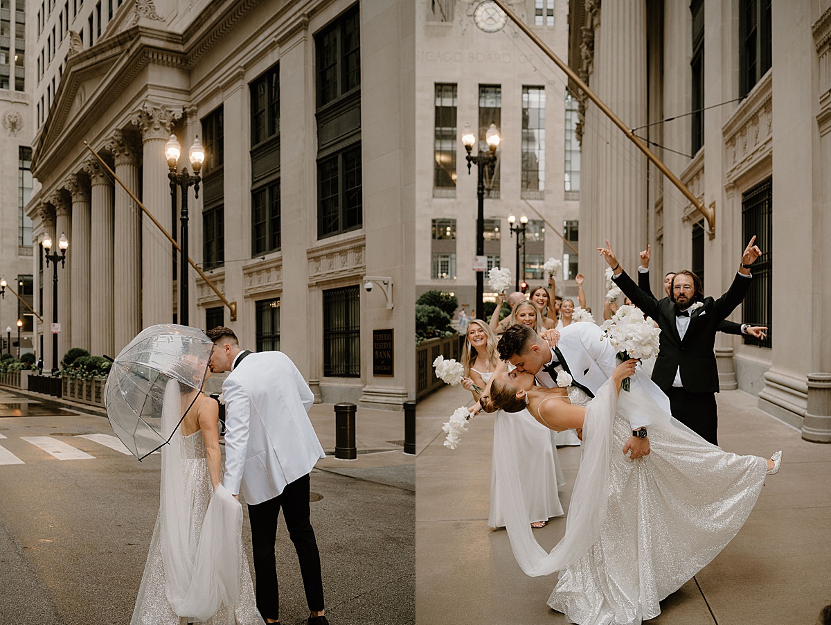 bride and groom in white with clear umbrella pose in front of city facade before ceremony shot by Midwest wedding photographer 