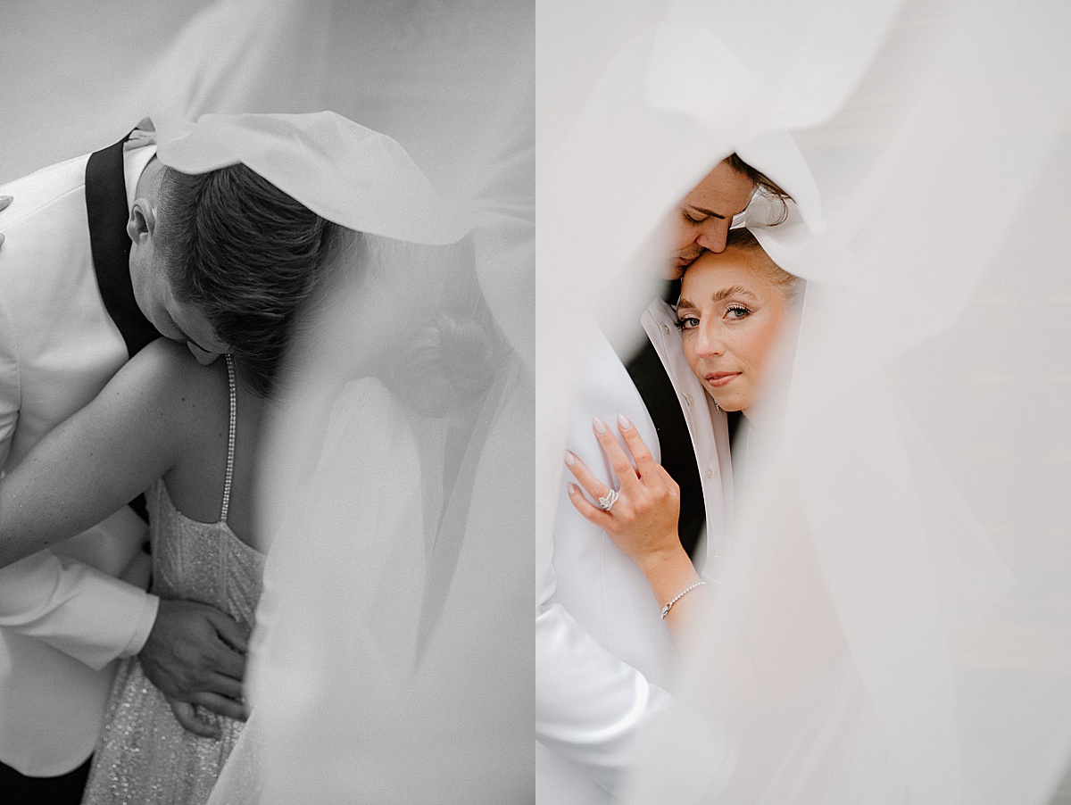 bride and groom pose as veil floats around them before glamorous ceremony shot by Midwest wedding photographer 