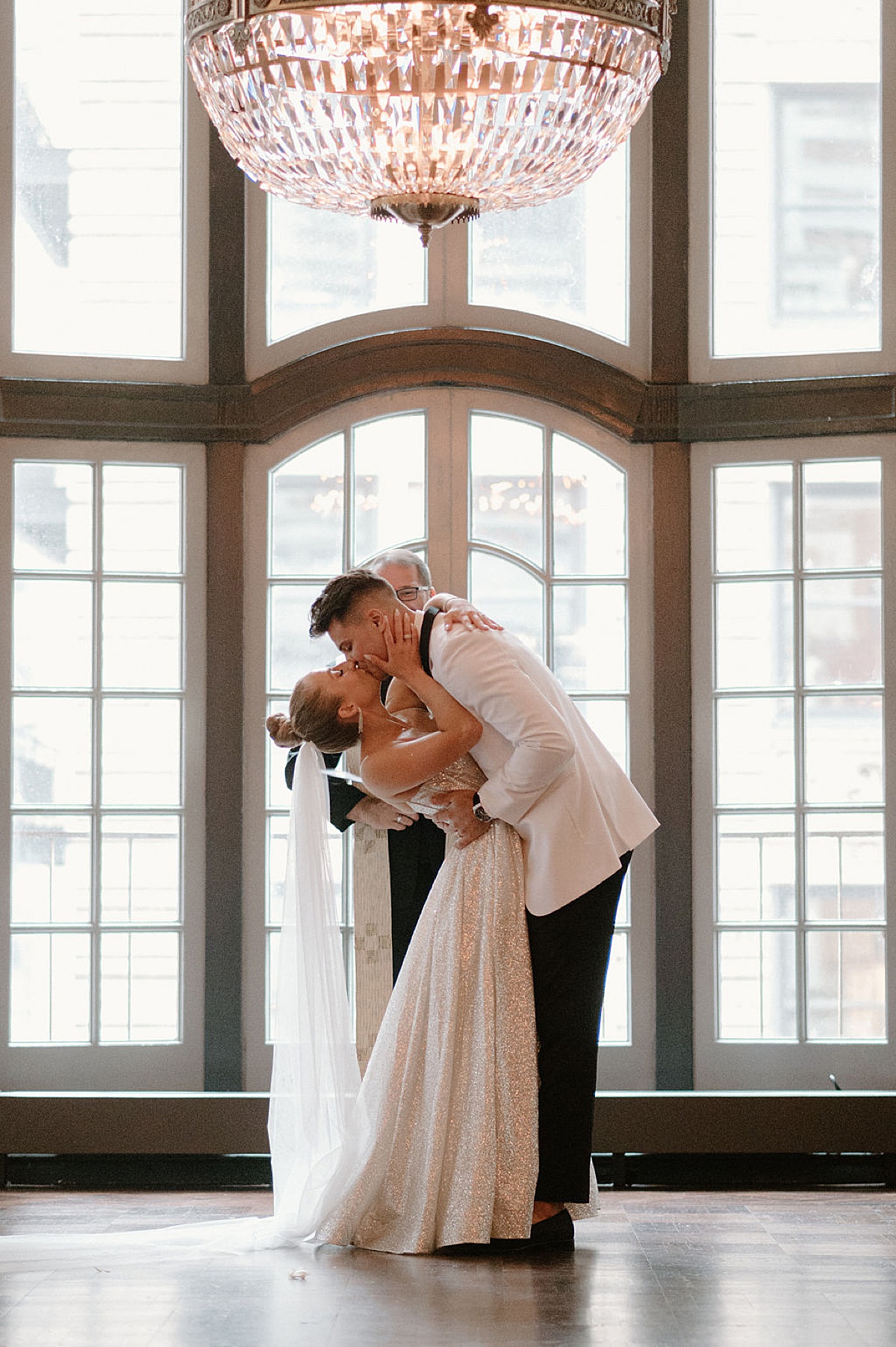 glam bride and groom kiss during ceremony shot by Midwest wedding photographer 
