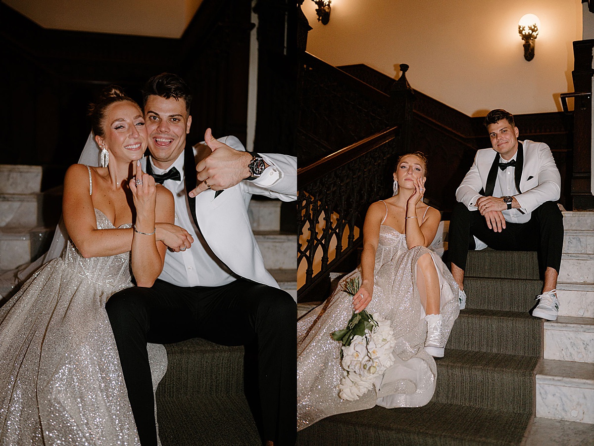 young glamorous bride and groom pose on hotel stairwell in fancy attire and sneakers for fun portraits by Indigo Lace Collective