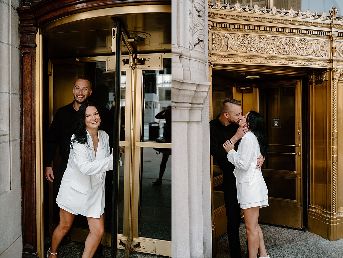 engaged couple pose in elegant casual wear in front of golden city door during shoot with Chicago wedding photographer