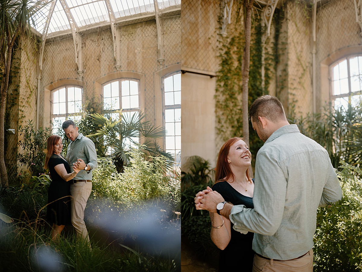 Couple slow dances in old English greenhouse during Wrest Park Engagement session