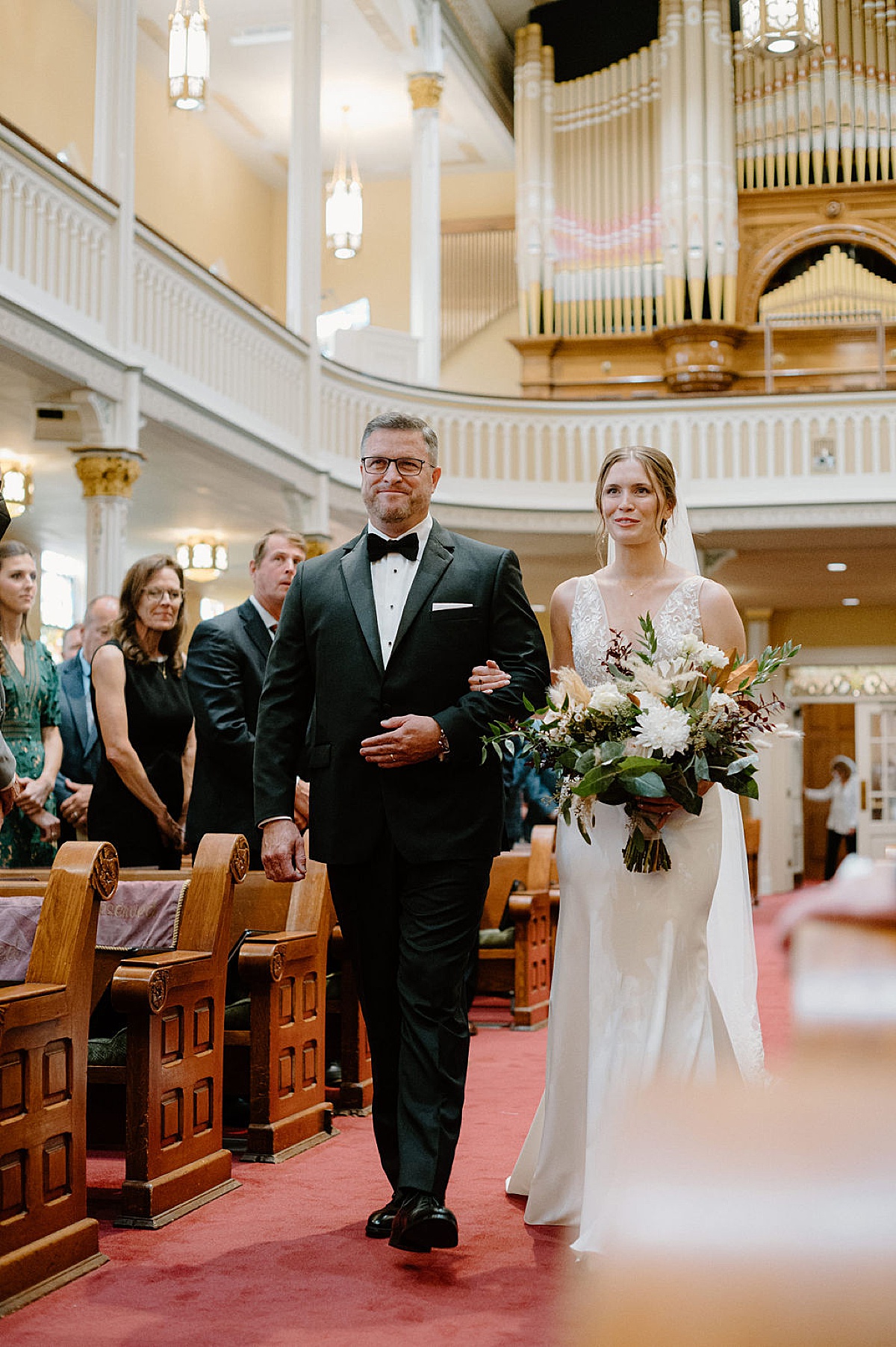 bride walks the aisle with her father during church ceremony at Idyllic Fort Wayne country club wedding