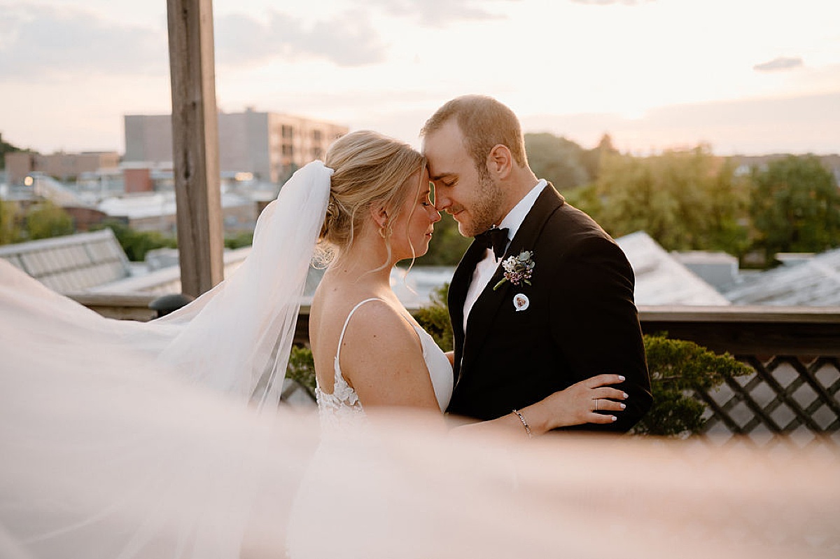 bride and groom stand on sunset rooftop after intimate Chicago ceremony