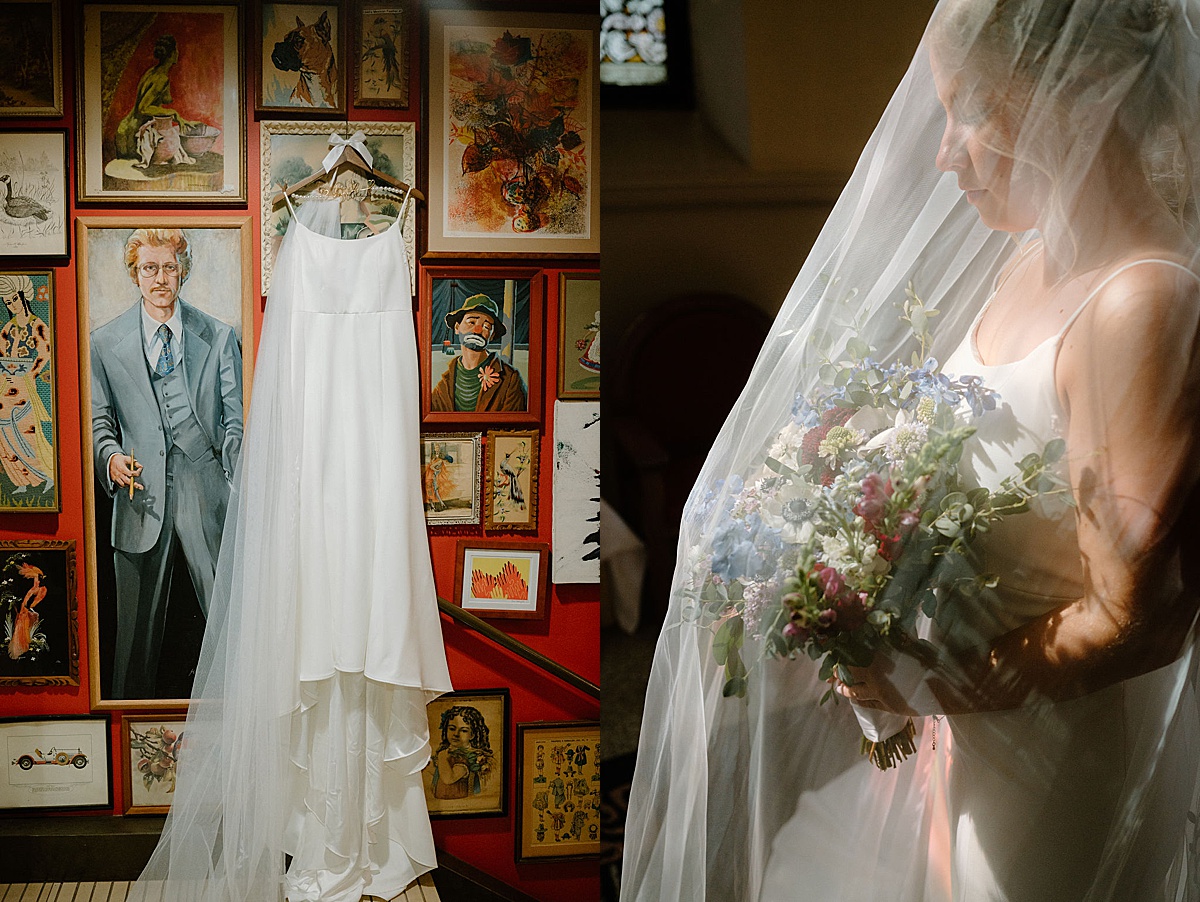 bride's gown hangs on dramatic art wall before bridal portraits shot by Indigo Lace Collective