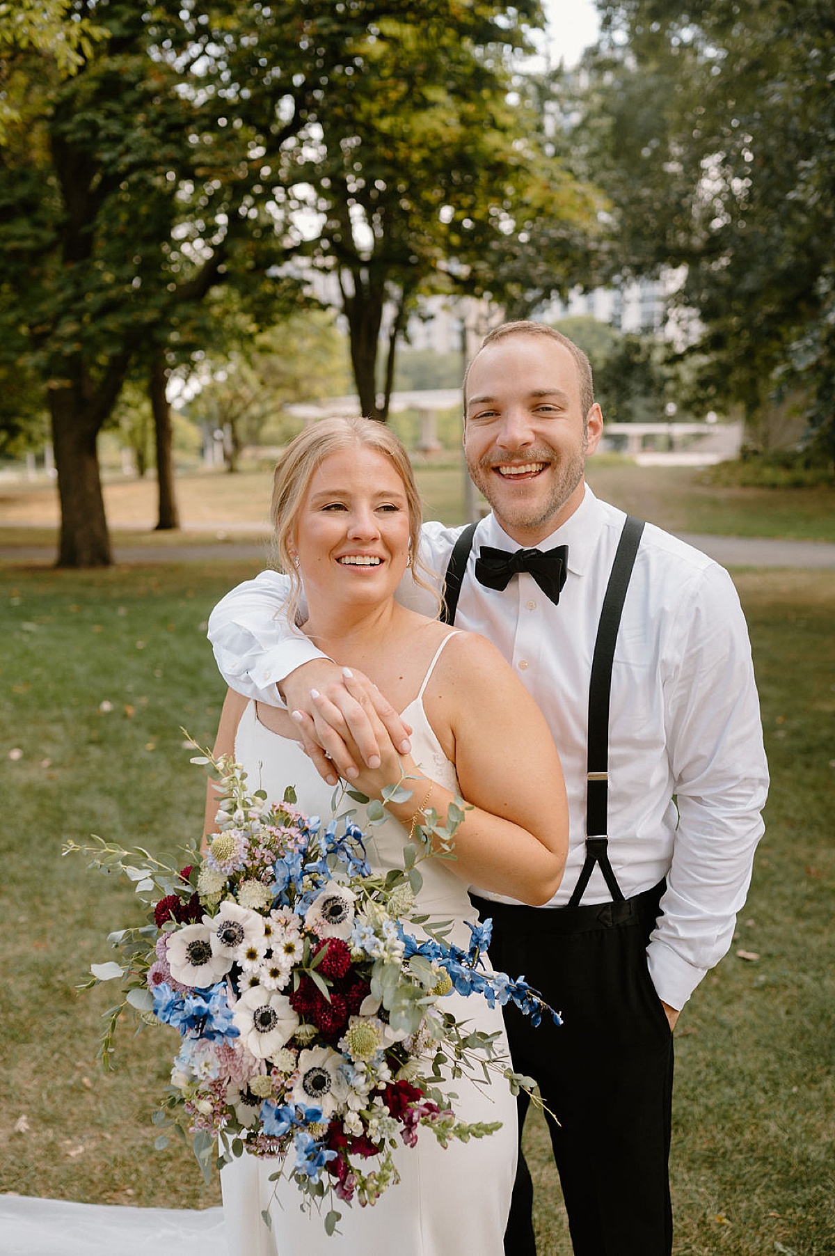 bride and groom pose in Chicago city park after sweet ceremony shot by midwest wedding photographer