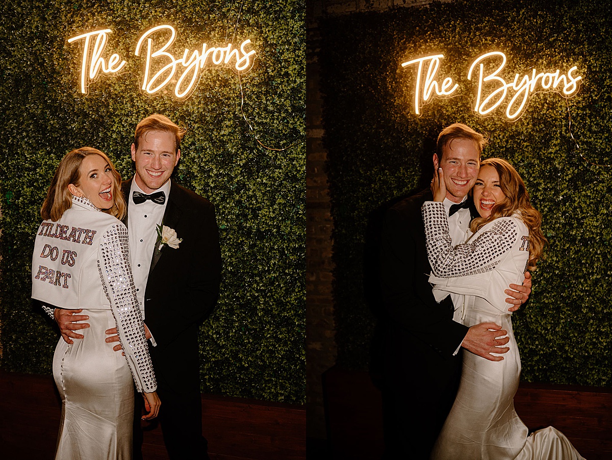 rock and roll bride and groom pose in front of ivy wall with neon sign after reception shot by Chicago wedding photographer