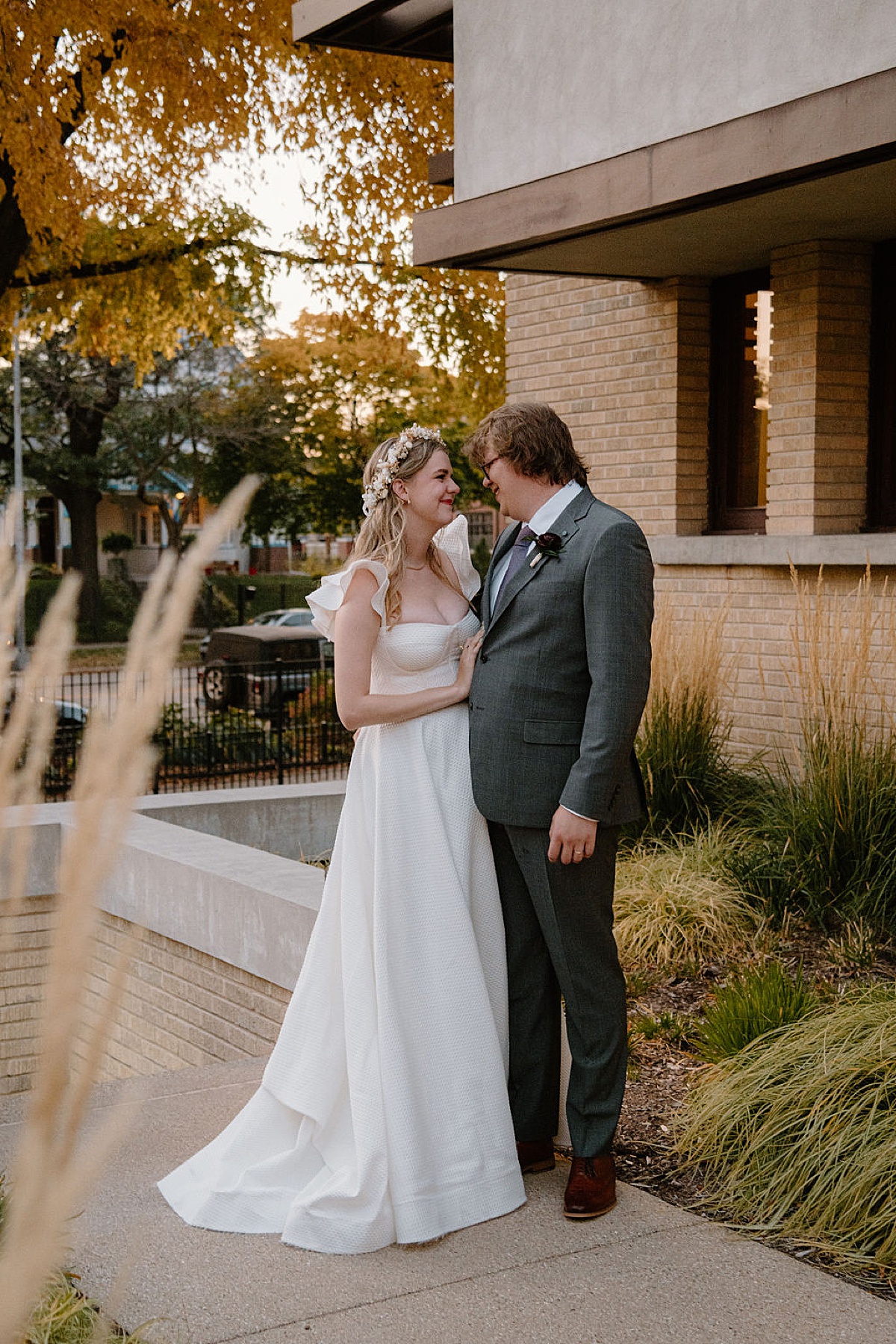cute vintage bride and groom share a moment outside Frank Lloyd Wright house in Chicago shot by Indigo Lace Collective