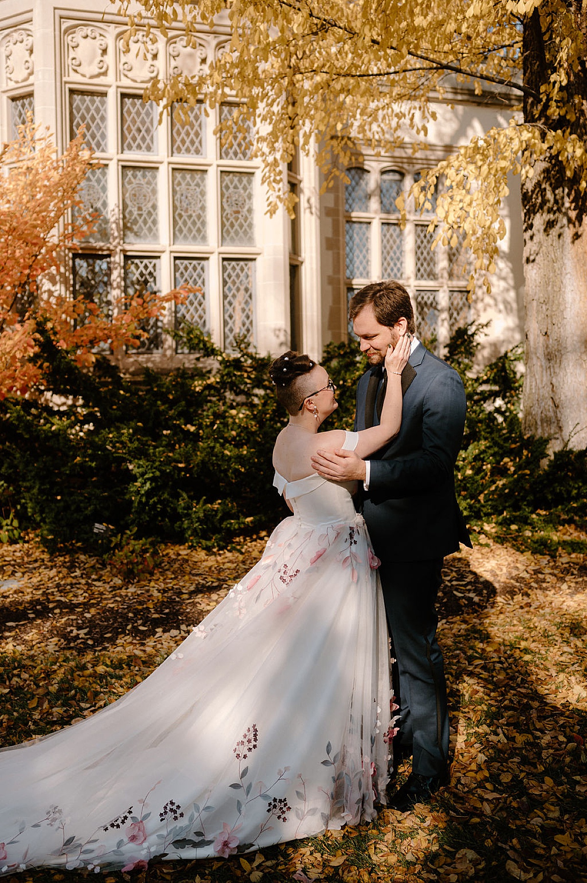 bride and groom share tender moment during first look at romantic autumn arboretum wedding