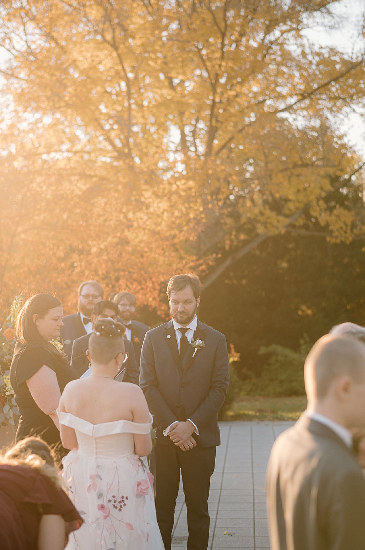 bride and groom read their vows during golden hour shot by midwest wedding photographer