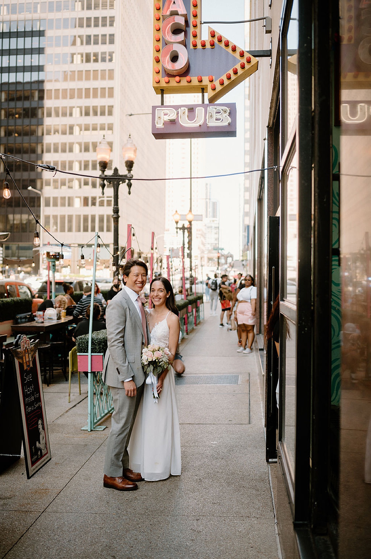 cute newlyweds pose outside taco shop where they had their first date | Chicago wedding photographer