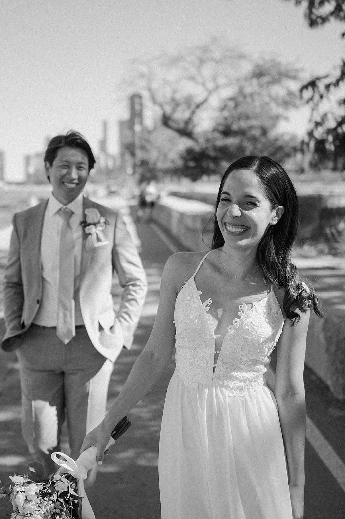 bride and groom grin with happiness after cute city elopement shot by Indigo Lace Collective
