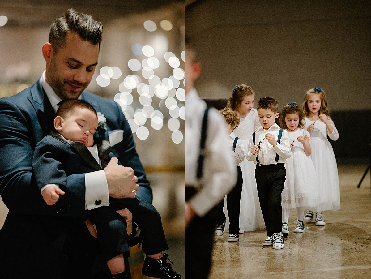 groom cuddles one year old son while flower girls walk up the aisle blowing bubbles | Chicago wedding photographer