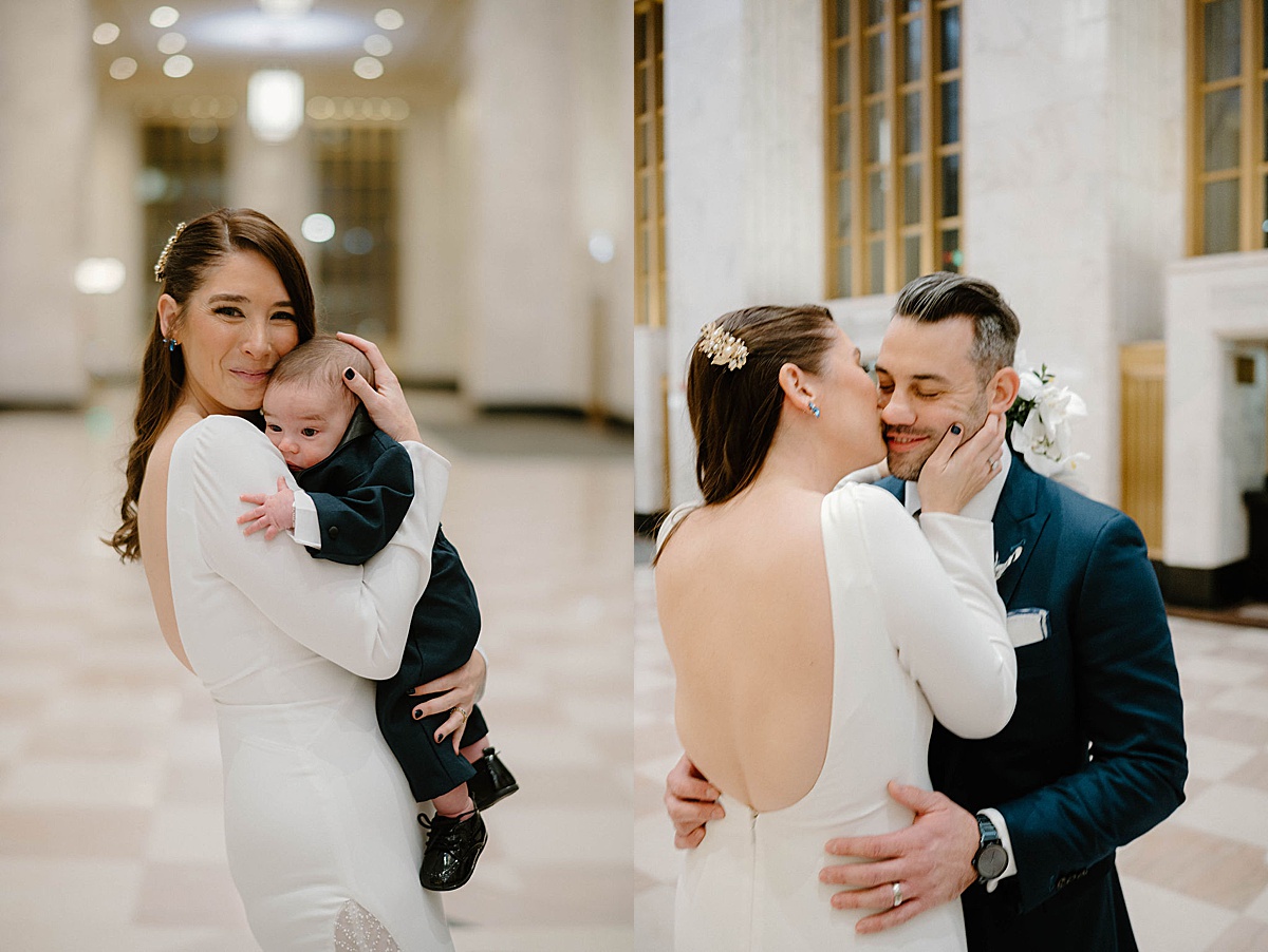 bride in elegant wedding gown poses with groom and infant son in amazing old post office shot by Chicago wedding photographer