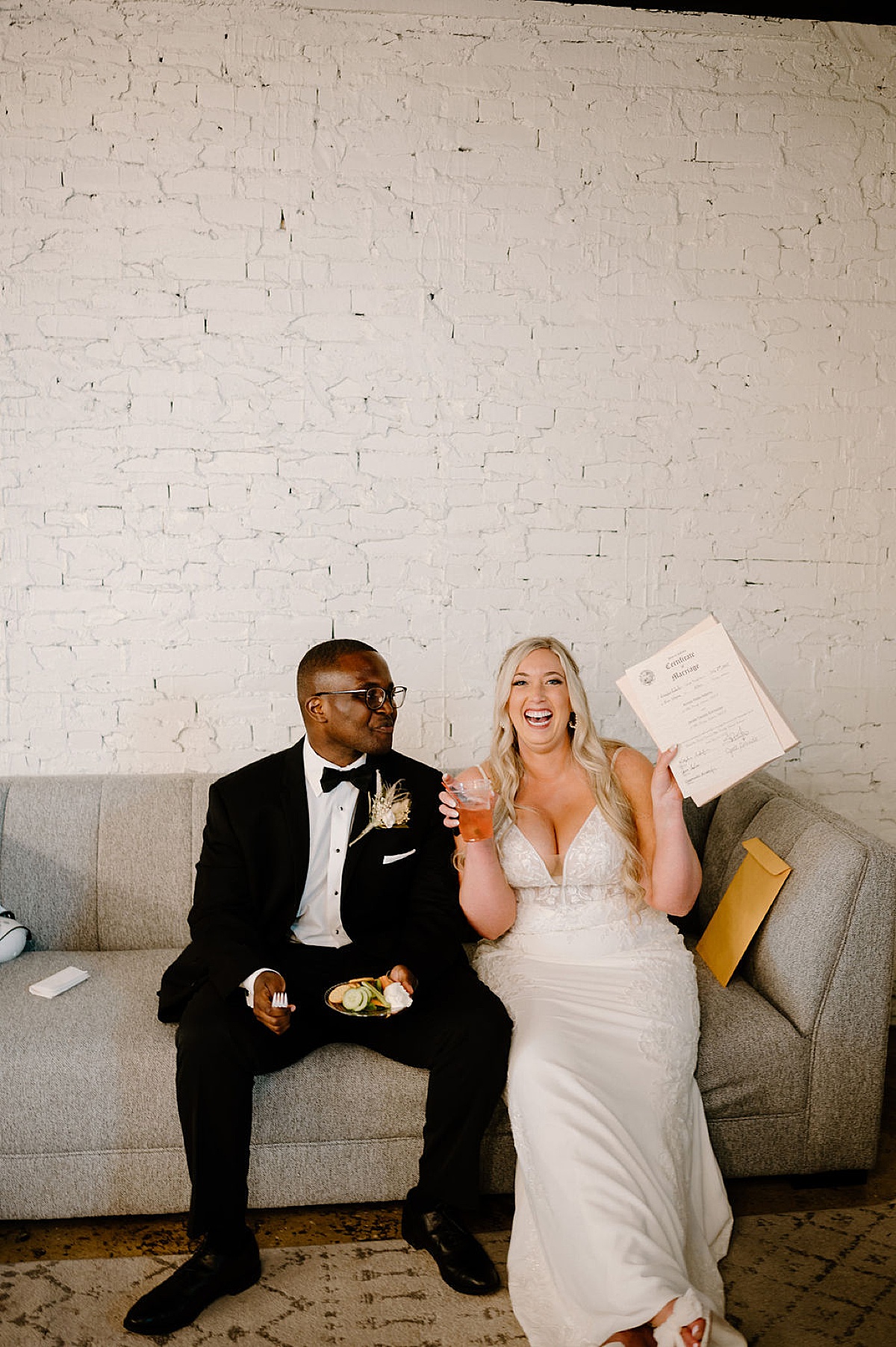 bride and groom share cocktails and appetizers as they show off signed matrimony papers after sunny Paper Mills ceremony
