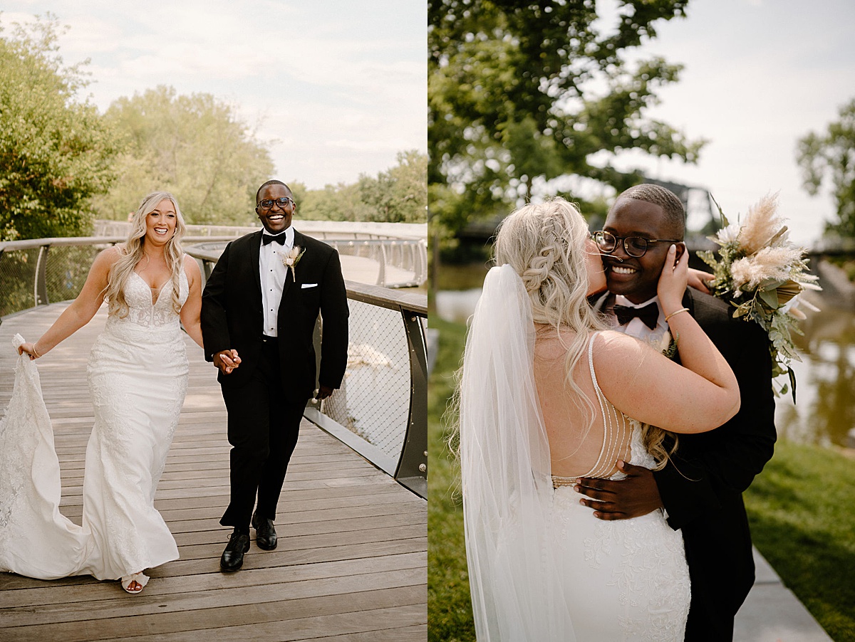 bride in elegant lace gown poses with dapper groom on river boardwalk shot by midwest wedding photographer