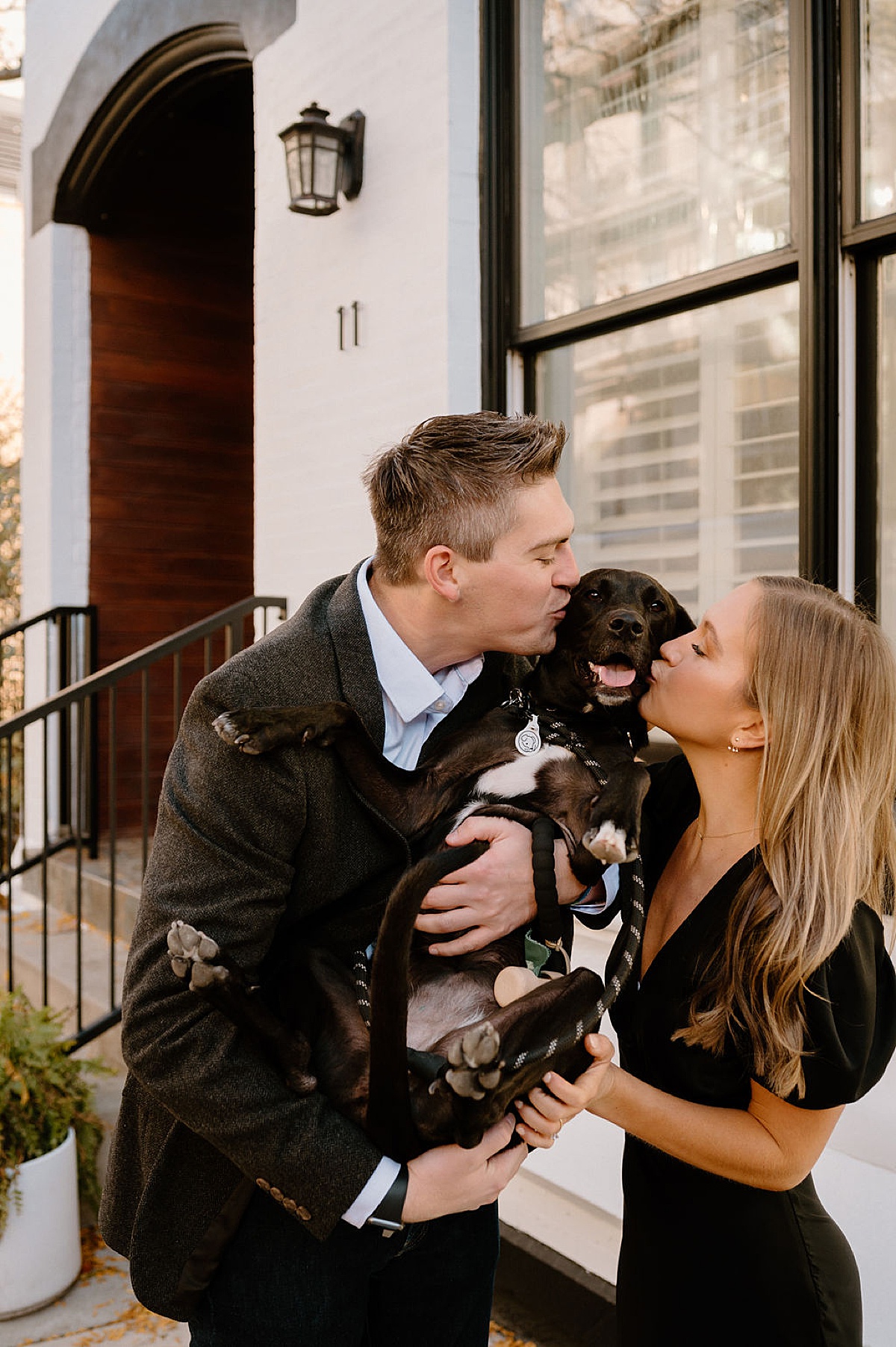 couple kiss their dog on the cheeks during puppy love engagement session