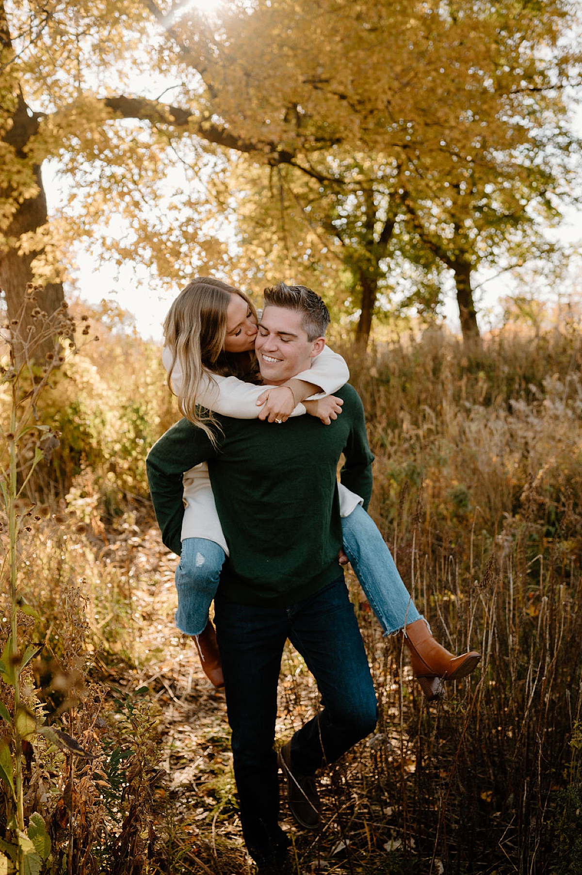 engaged couple pose in golden fall woods during shoot with Chicago wedding photographer