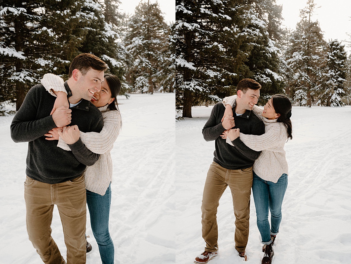 man and woman in outdoorsy sweaters hike through snowy park during shoot with Indigo Lace Collective
