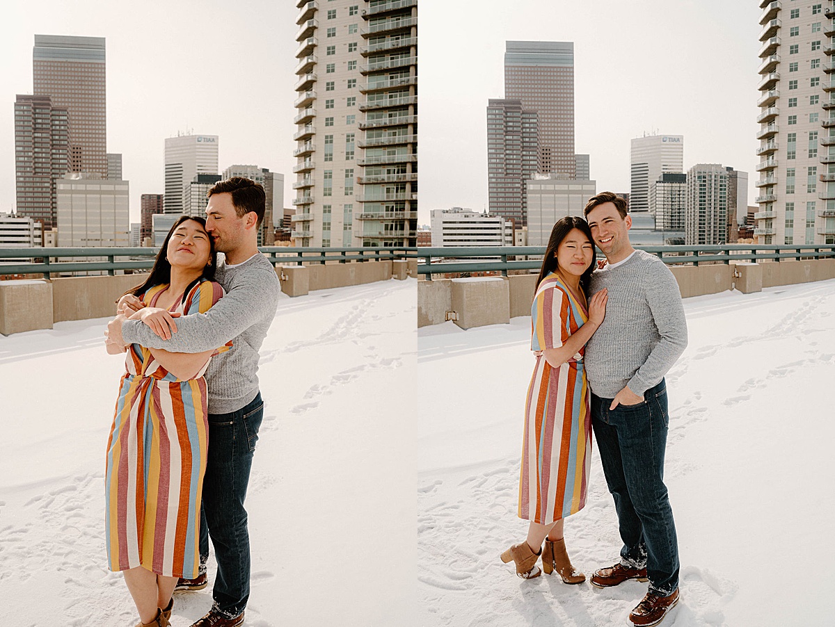 man and woman embrace on rooftop during sweet engagement shoot with Denver wedding photographer